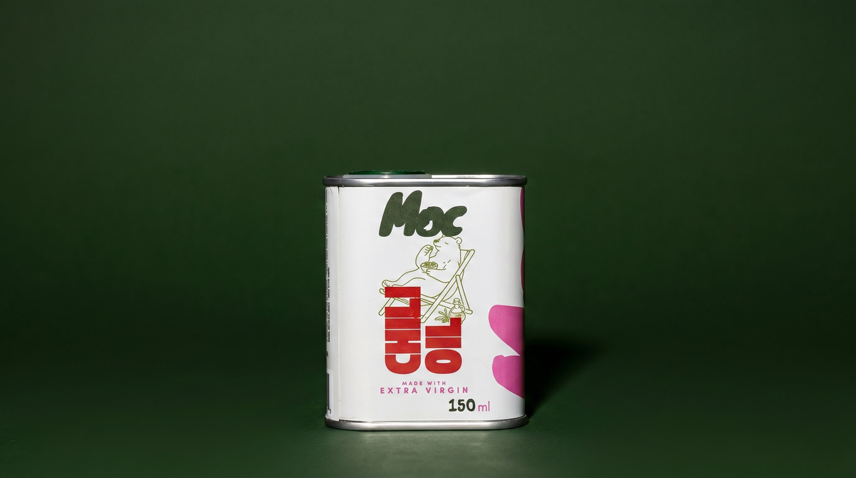 Tin of Moc Chili Oil, 150ml, against a dark green background