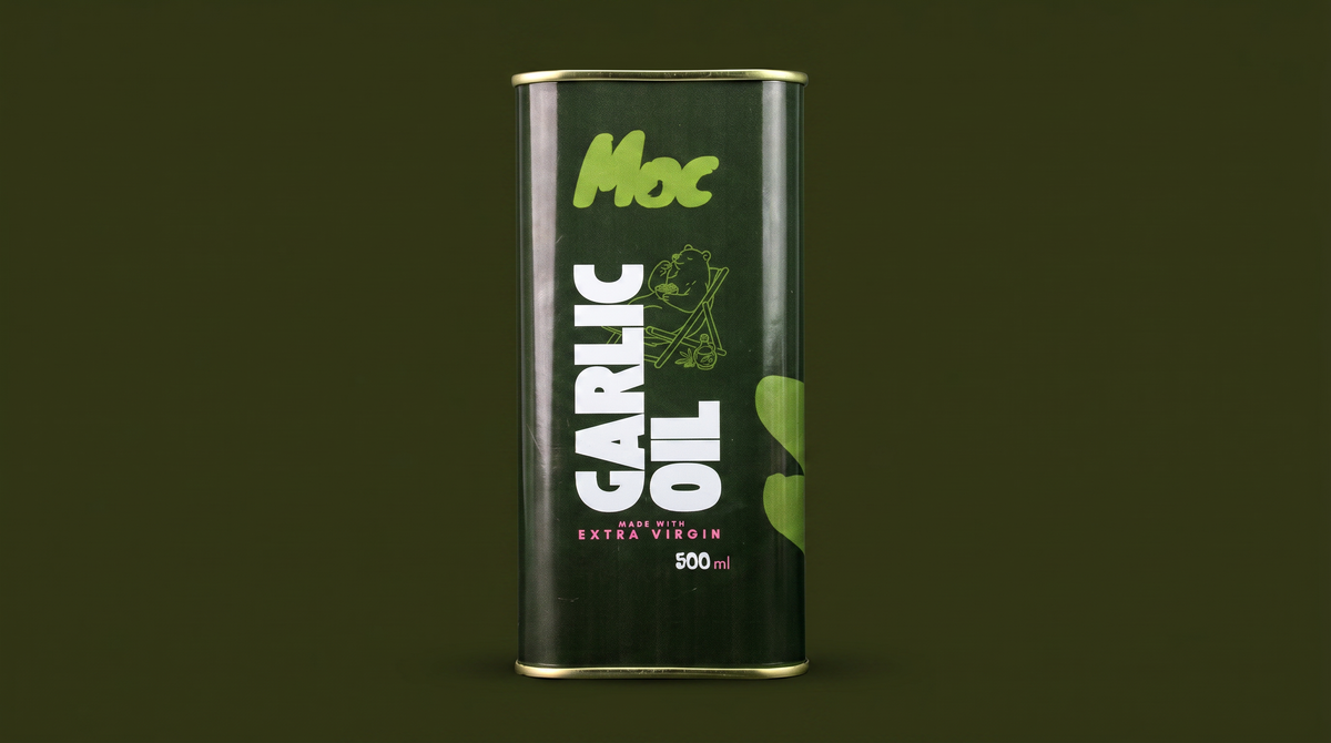 Tall green tin of Moc Garlic Oil, 500ml, against a dark green background