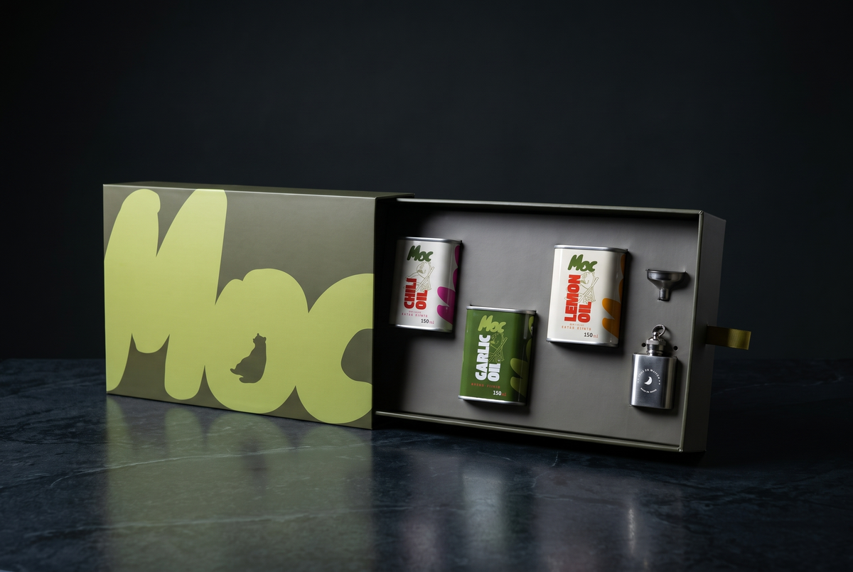 Open Moc gift box holding 150ml tins of Chili, Garlic and Lemon Oil with a funnel and refillable key-ring flask